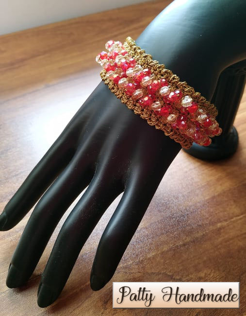 Bracciale realizzato ad uncinetto con filato lurex e mezzi cristalli rossi e avorio