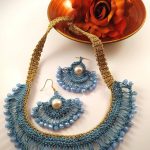 Collana e orecchini realizzati ad uncinetto con filato gioiello e mezzi cristalli sui toni dell'azzurro